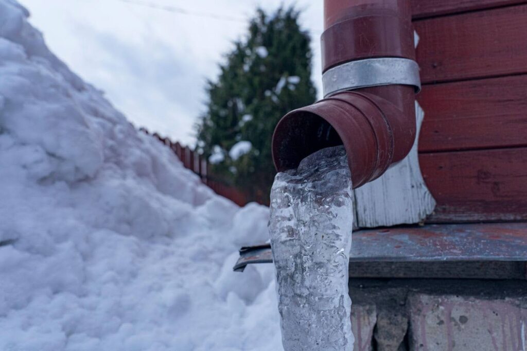 A pipe discharging ice resulting in a cool icy display