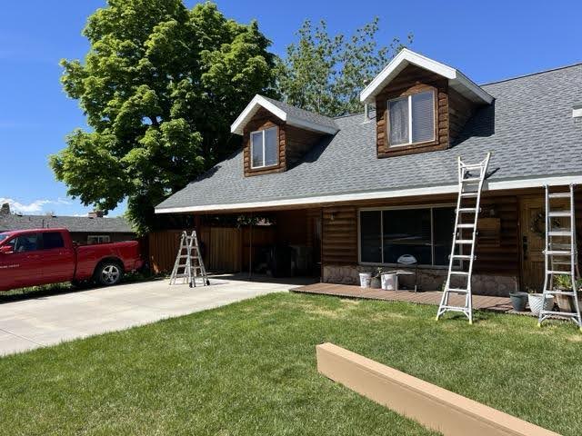 A house with a red truck parked in front showcasing a suburban setting with clear blue skies